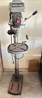 Full view of Porter-Cable floor-standing drill press showing base, column, table and head
