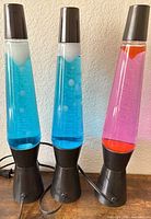 Front view of three lava lamps unplugged