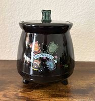 full view of cookie jar with lid on, showing house graphics