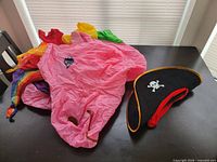 Costume and pirate hat laid on table