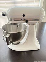 Right side view of white KitchenAid Ultra Power stand mixer with stainless steel bowl attached