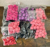 Bags containing assorted silicone beads in various shapes and colours