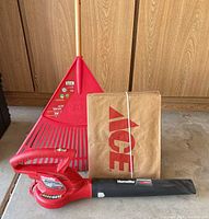 Group shot of leaf blower, rake, and bundled Ace bags
