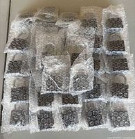 Bulk view of multiple bubble-wrapped padlocks