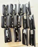 All 13 pinwheel instruments in individual black zippered cases, arranged in rows