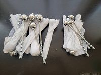 All 20 wrapped and unwrapped metal percussion massage wands grouped on surface