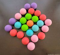 Top view of 26 multicolor rubber balls arranged in diamond shape