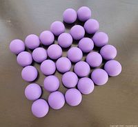 All 30 purple rubber balls arranged on surface