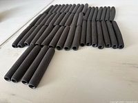 Overhead view of all 47 black foam grips grouped by size
