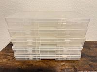 Stack of five clear plastic organizer boxes