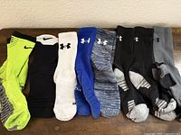 All eight pairs of socks laid out side by side showing colors and logos