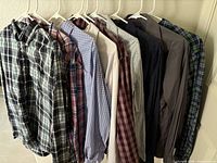 Front view of all nine shirts on hangers