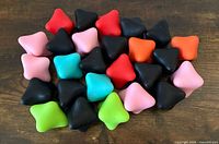 All 26 silicone hex balls grouped on wood surface