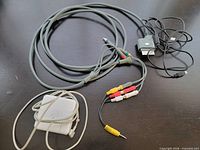 All three cables laid out: Apple power adapter, Xbox 360 component AV cable, mini-USB cable