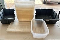 Group of bins showing large gray bin, stack of clear bins, small gray bin, clear organizer and rounded bin