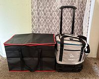 Cooler on wheeled base next to insulated bag