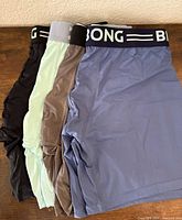 Four boxer briefs laid flat showing colour variety and waistbands