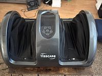 Front view of Tisscare foot and calf massager showing control panel and cavities