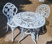 Full view of table and two chairs outdoors