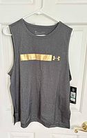 Front view of charcoal grey Under Armour tank top with tag attached