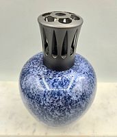 Full view of blue speckled porcelain Lampe Berger lamp with metal diffuser cap attached