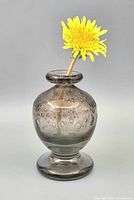 Full view of bud vase with flower inserted showing overall form, rim, body, and controlled bubbles