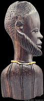 Side view of carved wooden African male bust with removable bead necklace