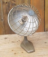 Full view of vintage tabletop reflector heater showing guard, reflector, element and base