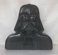 Front view of black plastic Darth Vader carrying case closed
