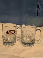 Front view showing both mugs and logos