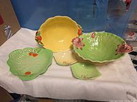 Group shot of five pottery pieces showing shapes and colors