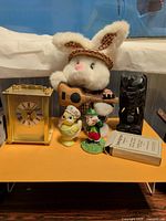 Full lot with clock, plush rabbit, figurines, tiki statue, playing cards