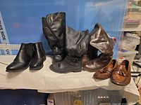 All four pairs of shoes on table