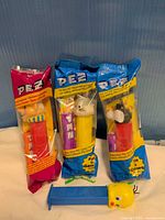 Three sealed PEZ dispensers and one loose Tweety dispenser