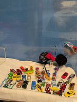 overview of lot showing cars, dinosaurs, figures, headband