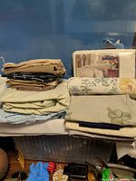 group of stacked sheets, packaged bedspread, rolled fabric