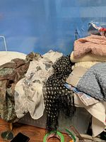 Group view of assorted scarves on bin