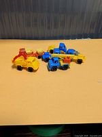 All seven miniature trucks grouped on surface