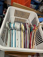 Top view of laundry basket filled with assorted plastic hangers
