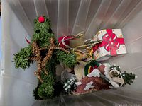 Top view of tote showing evergreen figure, faux gift box and assorted decor