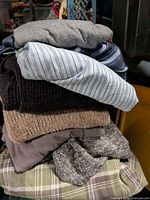 Stack of folded mixed garments showing various textures and colours