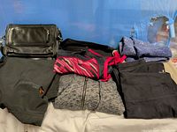 Overall lot showing bag, multiple folded garments