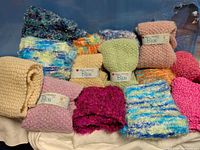 Group of folded knit scarves in various colours