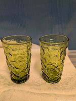 Two green textured tumblers side by side