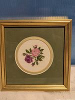 Front view of framed floral petit point artwork