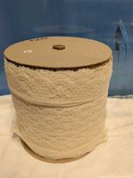 Full view of spool showing lace trim wrapped around