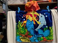 Front view of hooded poncho towel showing marine print and orange hood