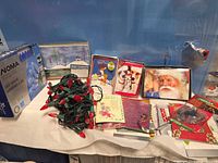 Assorted Christmas items laid out including Noma light box, greeting card boxes, loose novelty lights