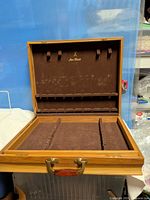 Chest open showing interior felt lining and logo