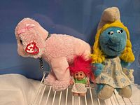 Front view of all three toys on wire shelf